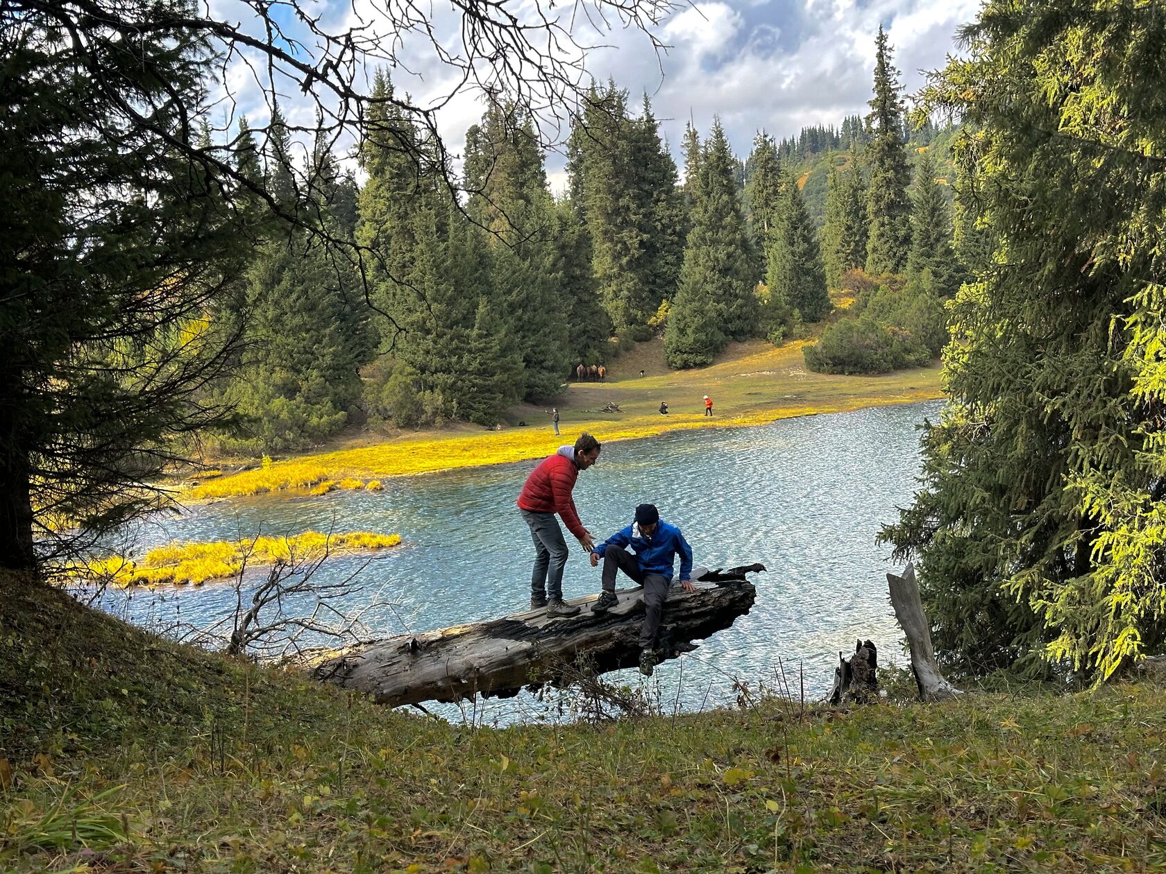 Turnaluu-Kol, the Crane Lake, surrounded by green alpine meadows and mountain ridges
