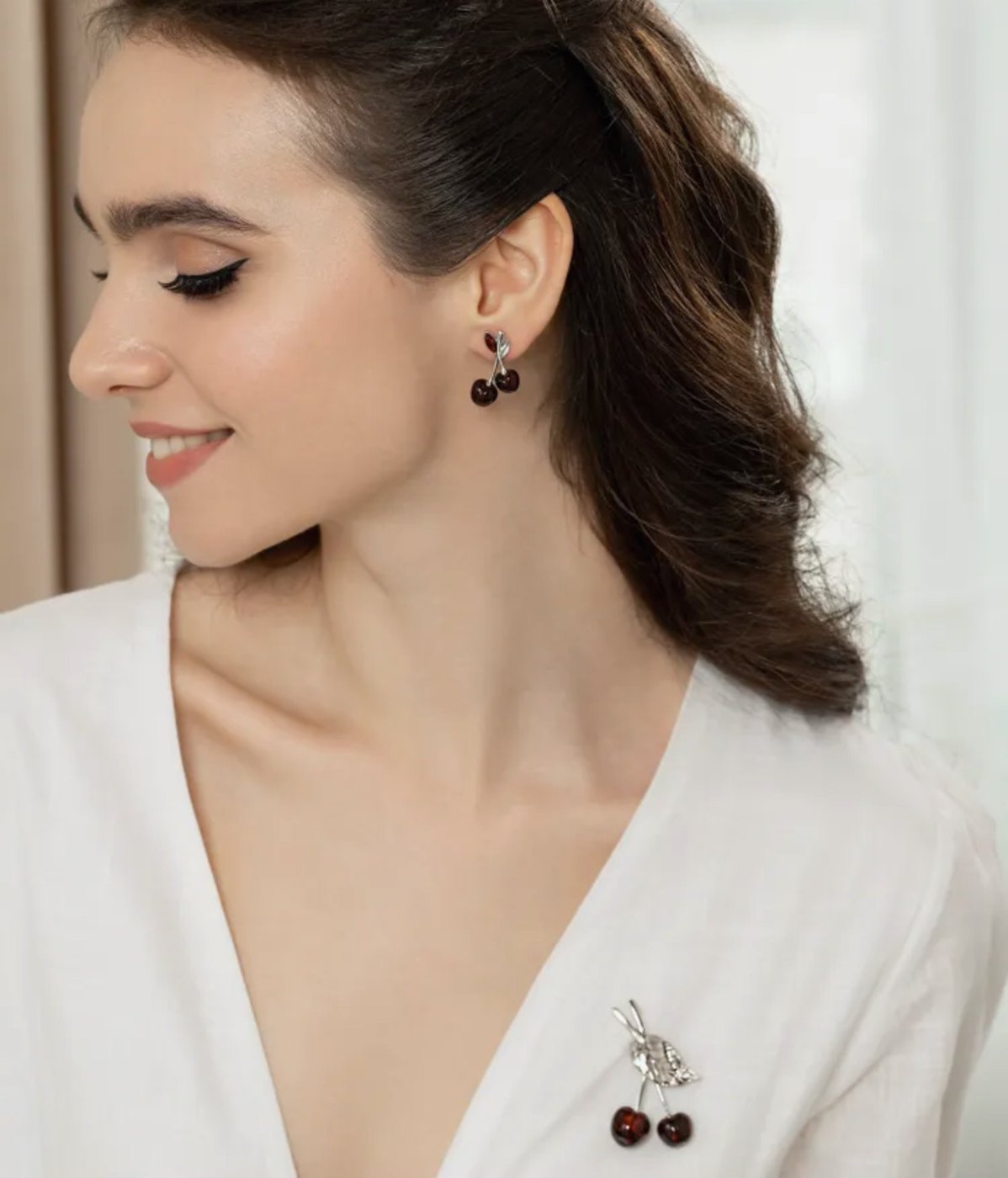 Cherry amber brooch worn on a white shirt