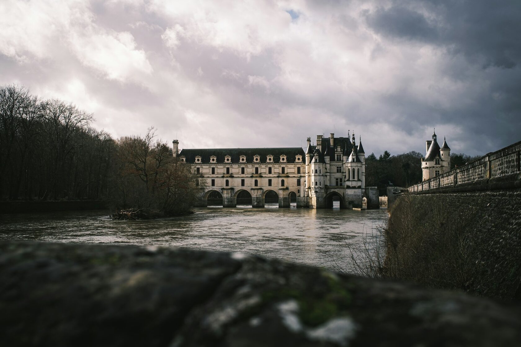 The Château de Chenonceau arching across the Cher River in soft morning light