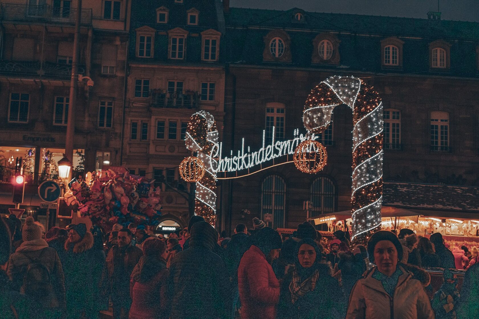Strasbourg's Christmas market glowing with lights at night beneath the cathedral spire