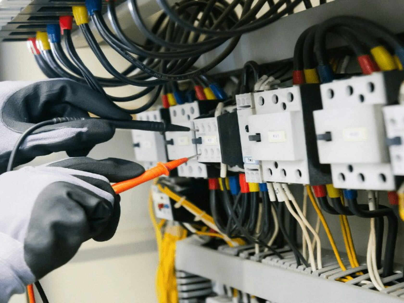 Electrician wiring an electrical panel