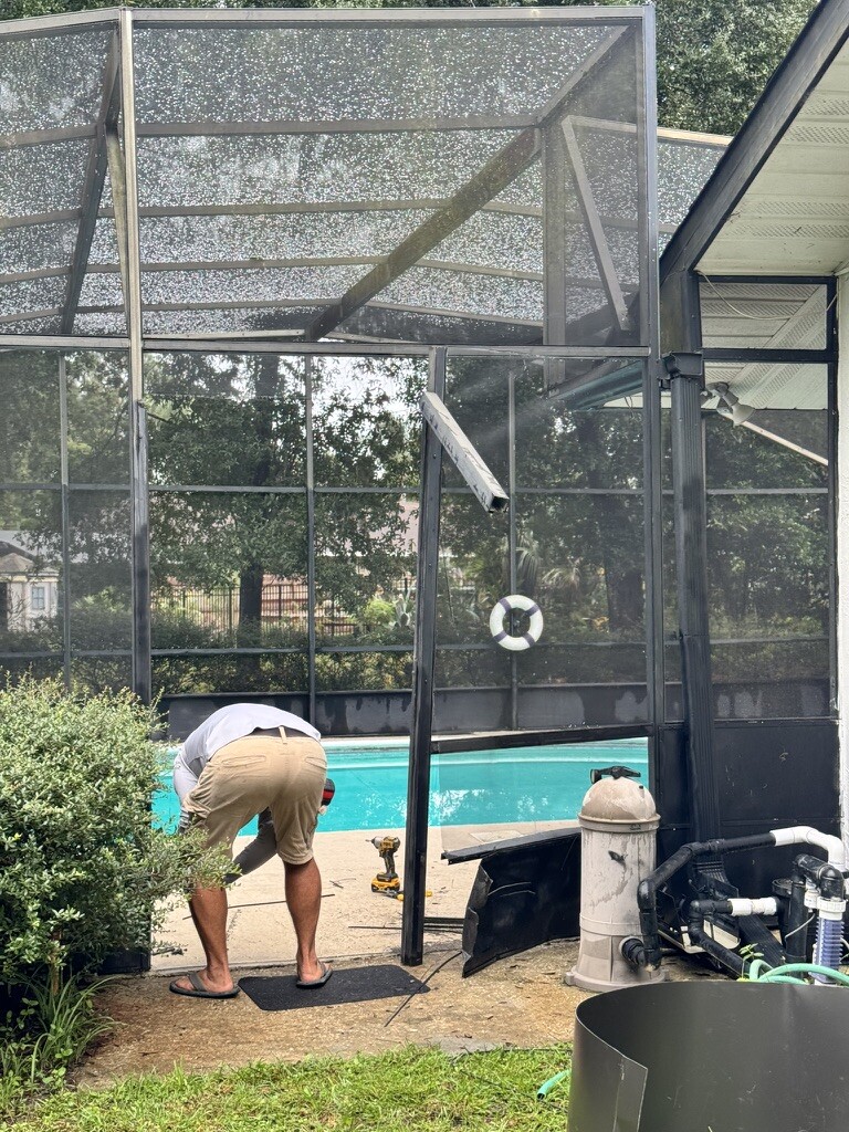 FullScreenFix technician repairing a pool cage