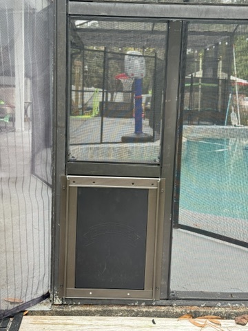 Aluminum pet door installed in a screen enclosure