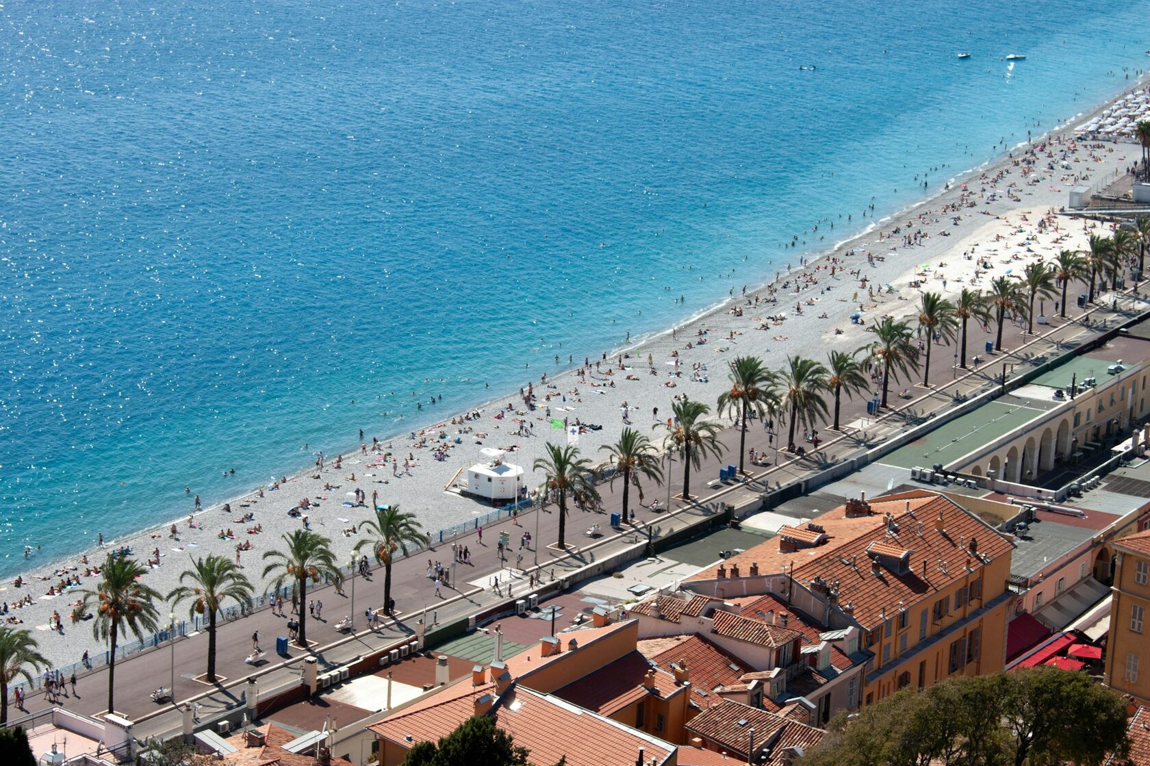 The Promenade des Anglais curving around the turquoise Baie des Anges in Nice