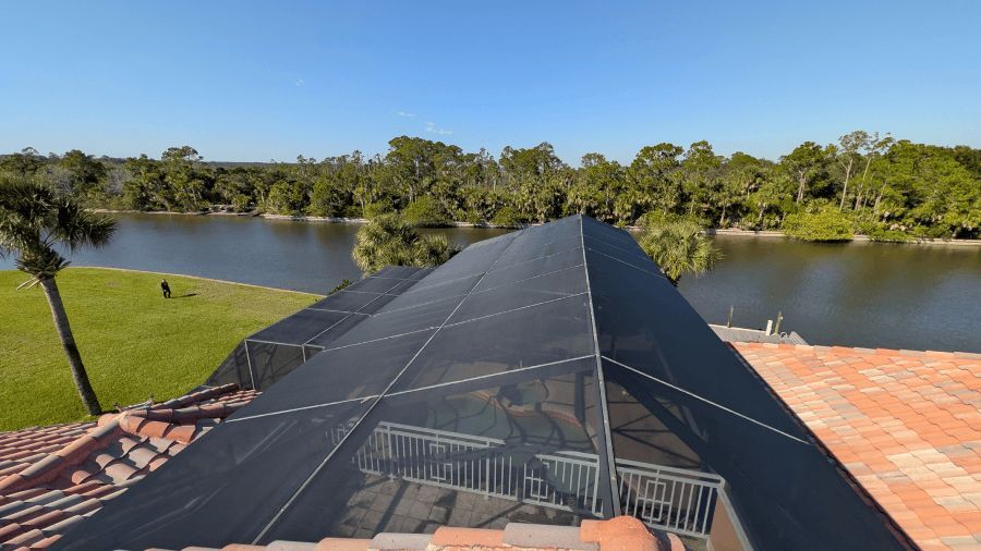 Pool cage by the lake after a full rescreen with new screen