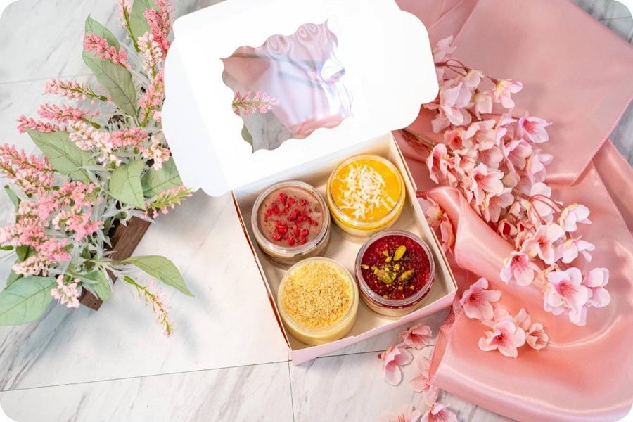 Dessert jars in a gift box by a window