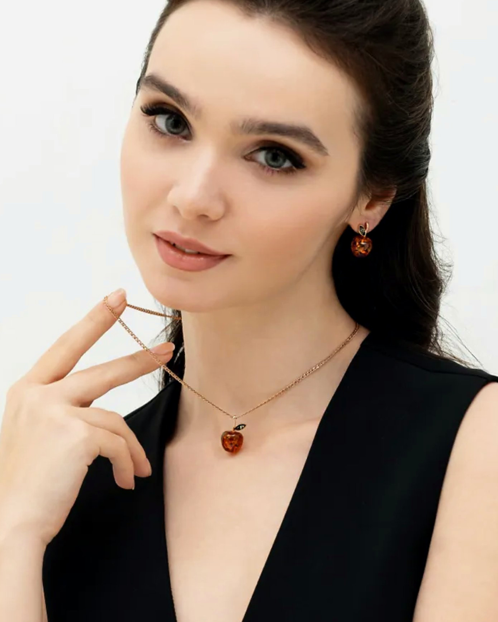 Model wearing the amber apple pendant and stud earrings