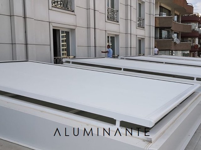 DAZZONI white fabric cover units on a roof terrace