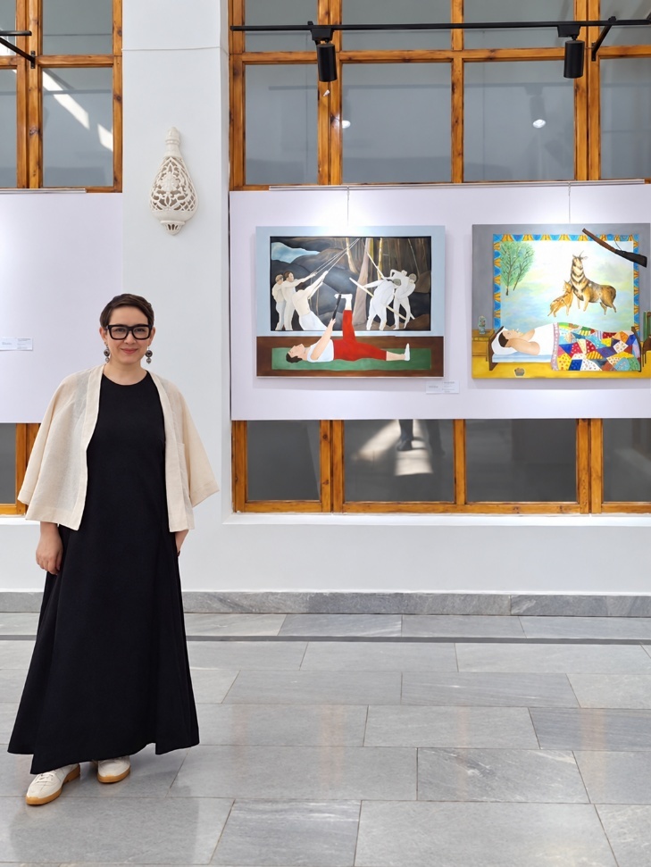 Uliana Novak with two paintings from her Carpets series