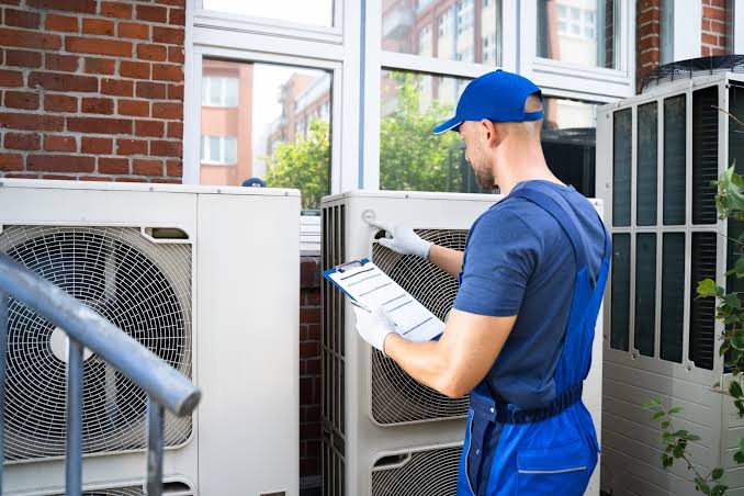 HVAC technician servicing an air conditioning unit