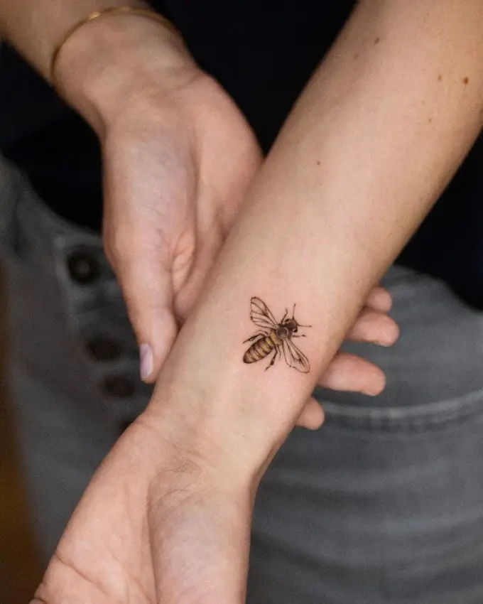 Fine line bee on the wrist