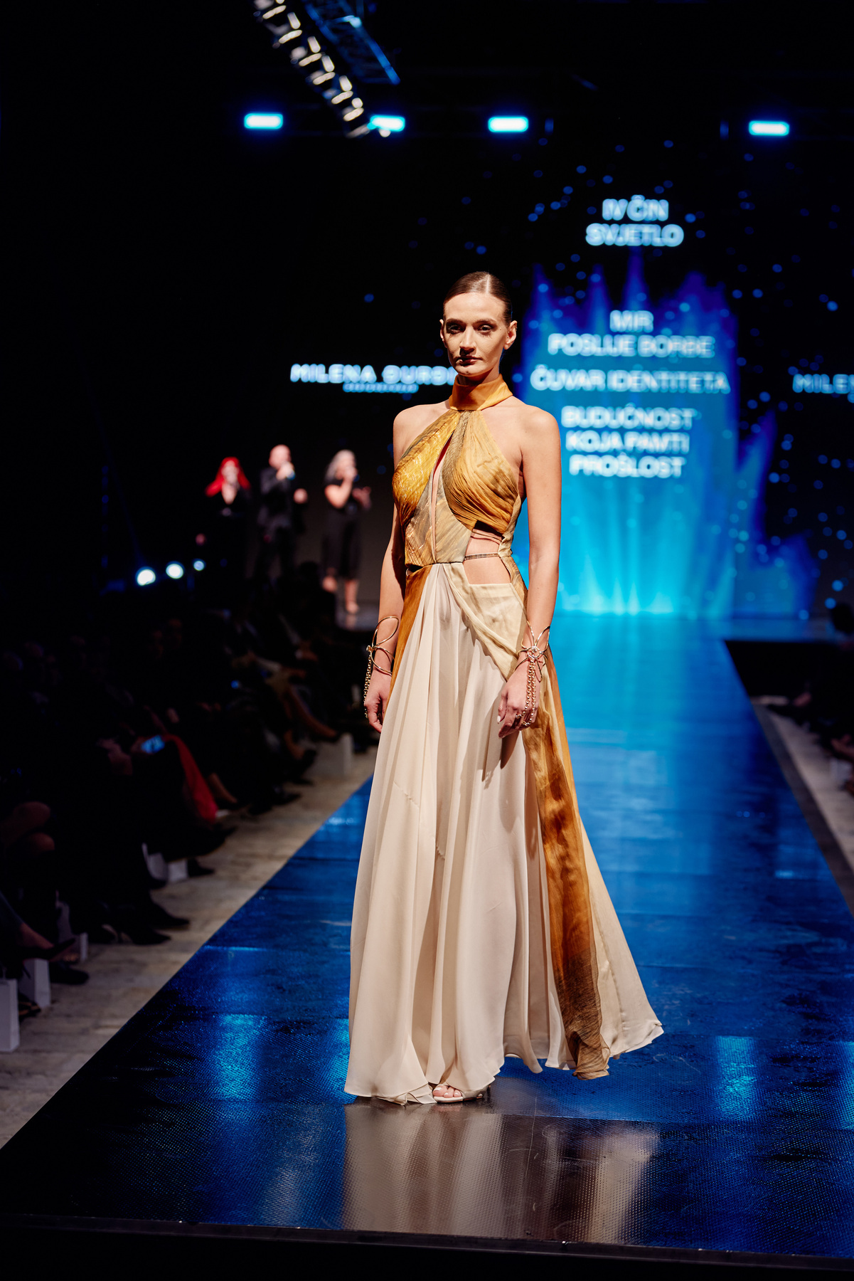 A flowing gold and ivory runway dress
