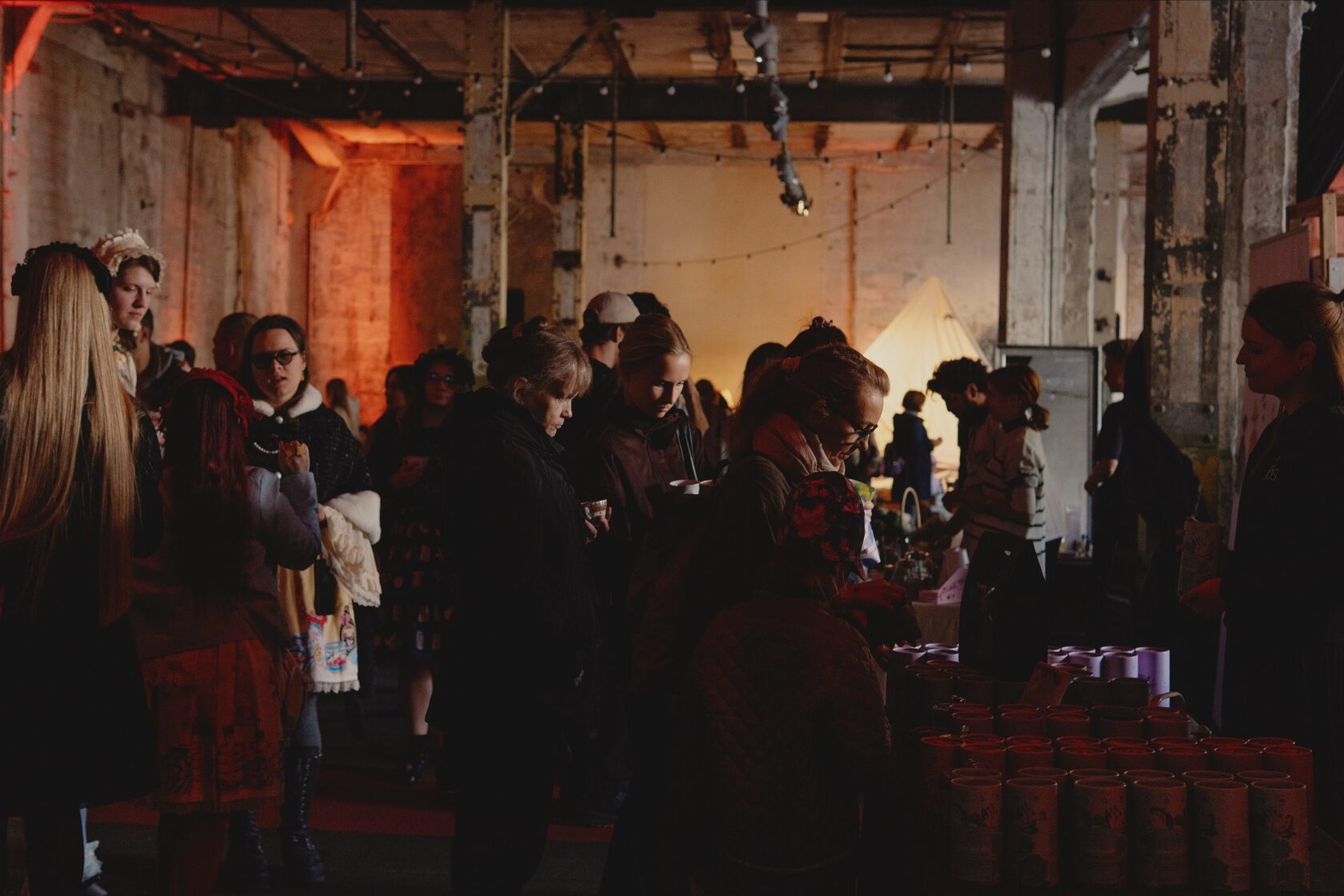 Guests browsing tea stalls in the factory hall at the Tallinn Tea & Matcha Festival