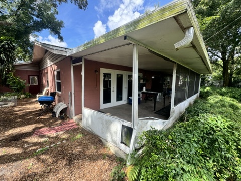 Screen porch with torn screens before repair