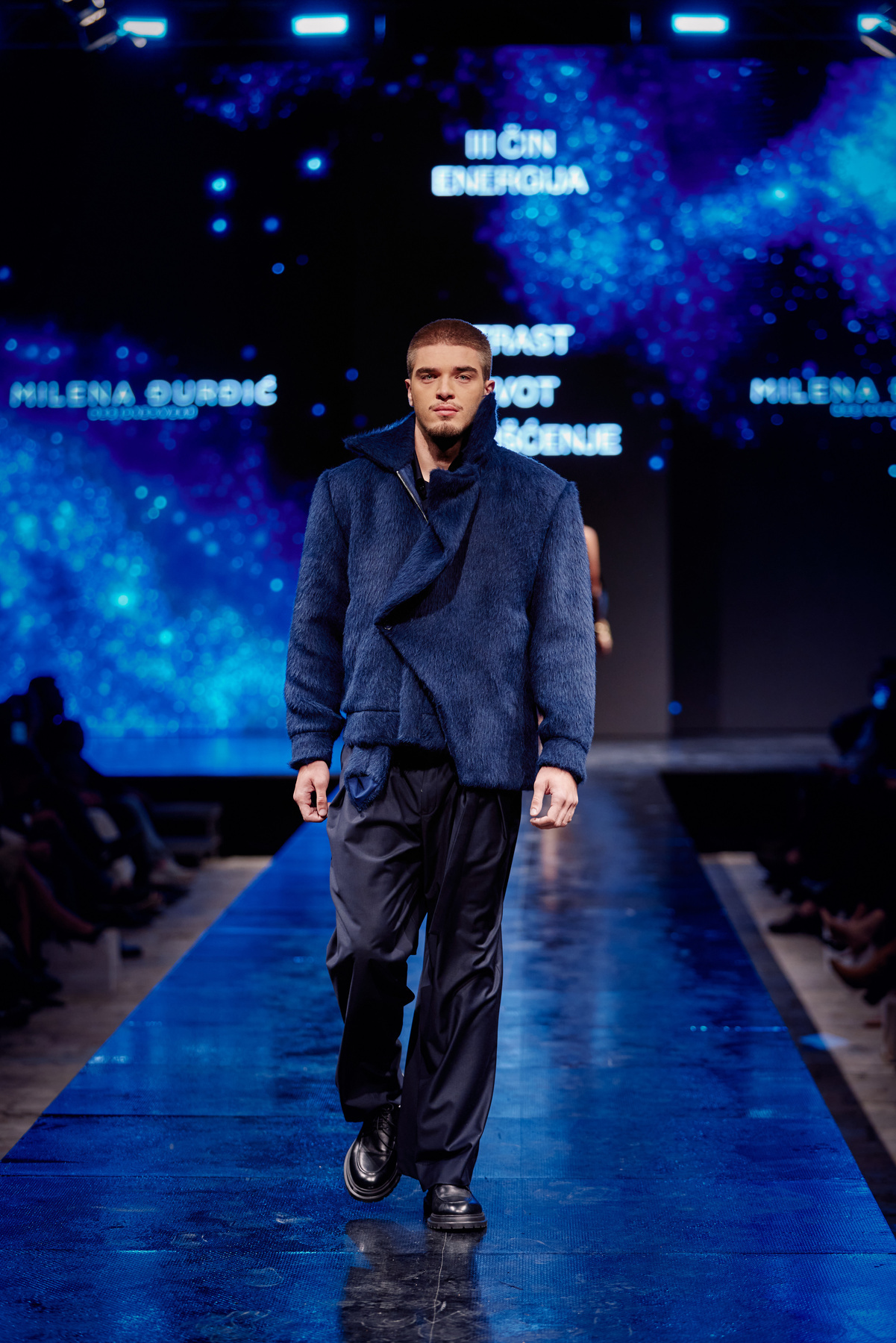 Dark blue textured menswear on the runway