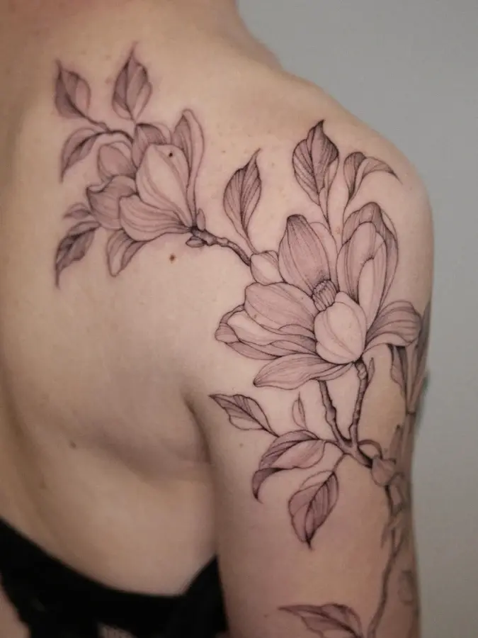 Fine line magnolias on the shoulder