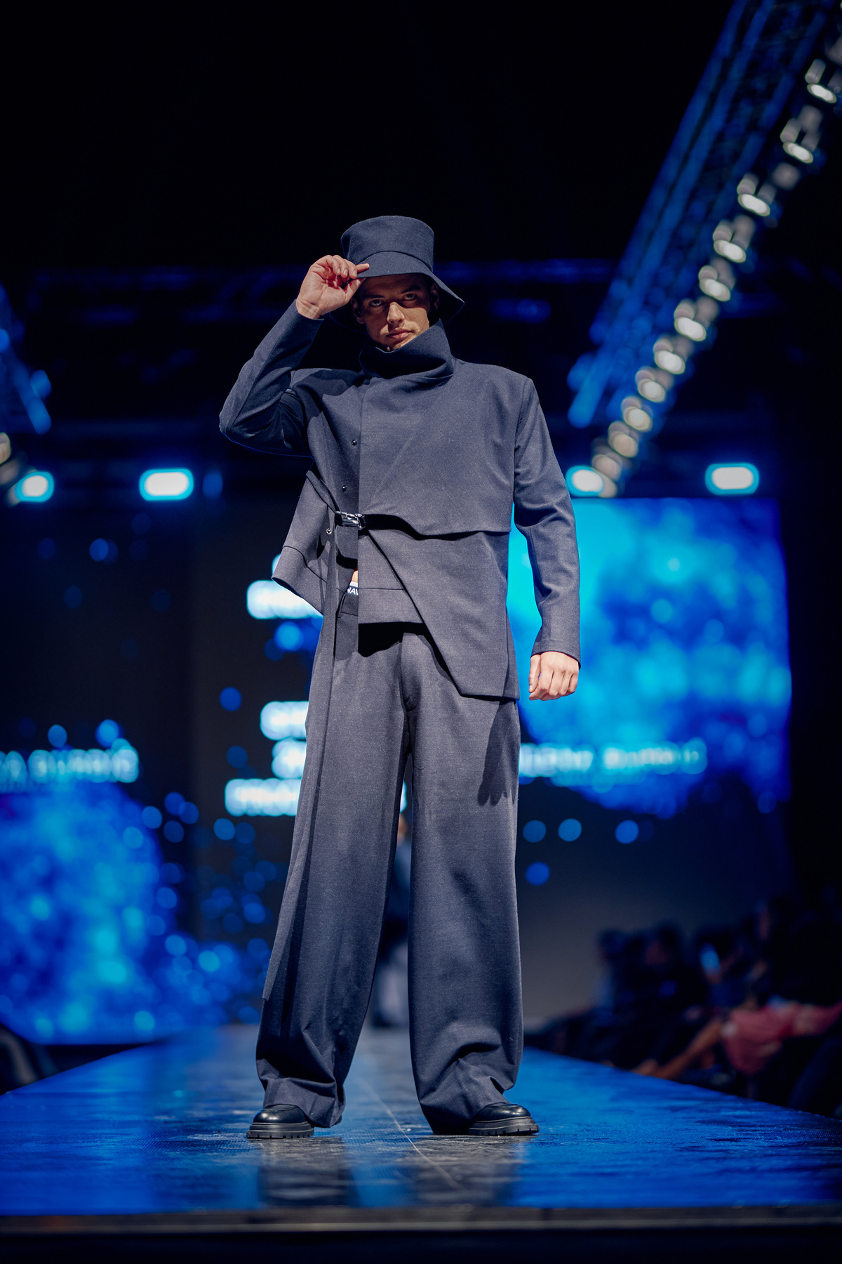 Black menswear with a sculptural hood