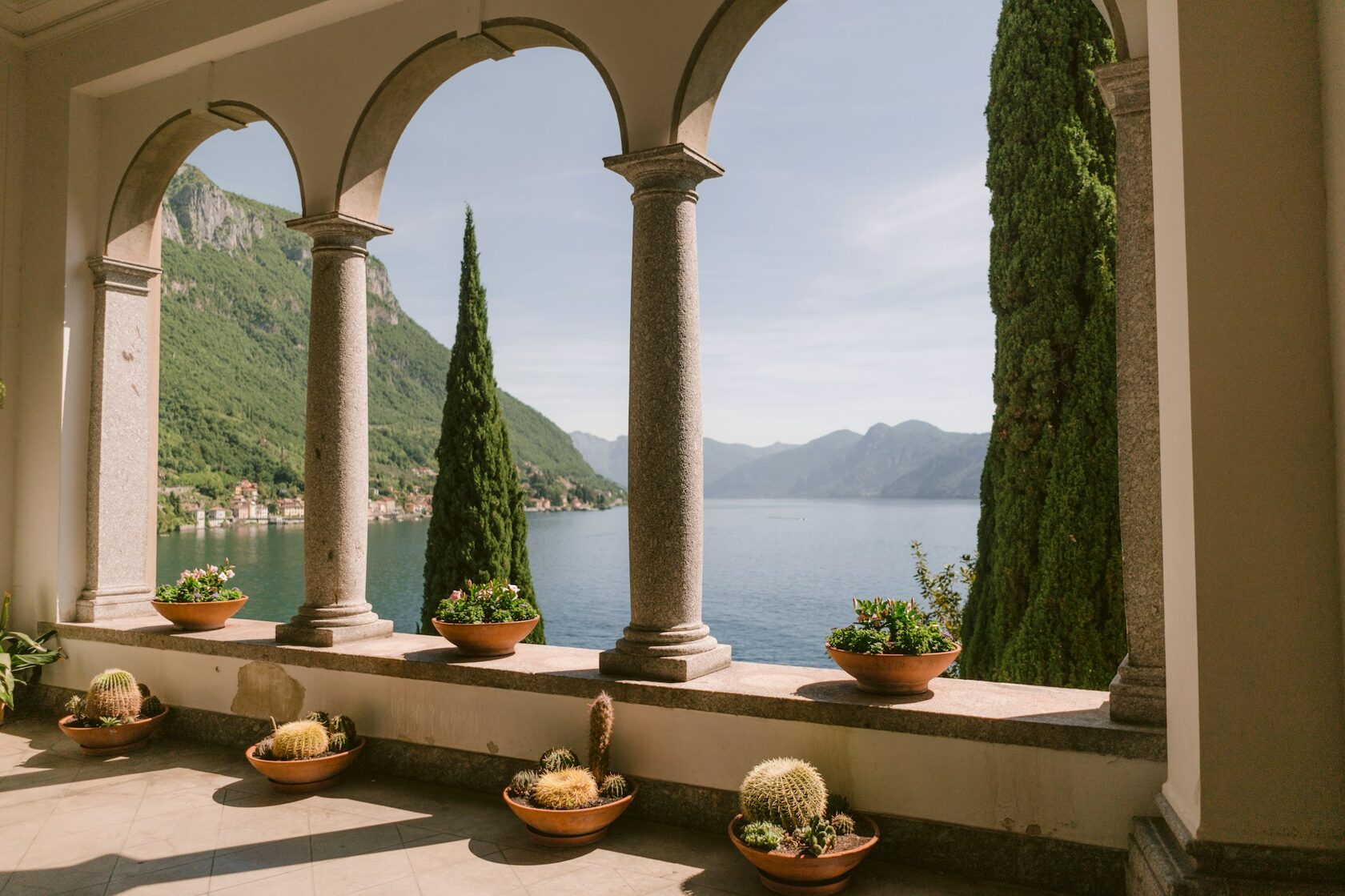 Italian lake with a villa and cypress trees