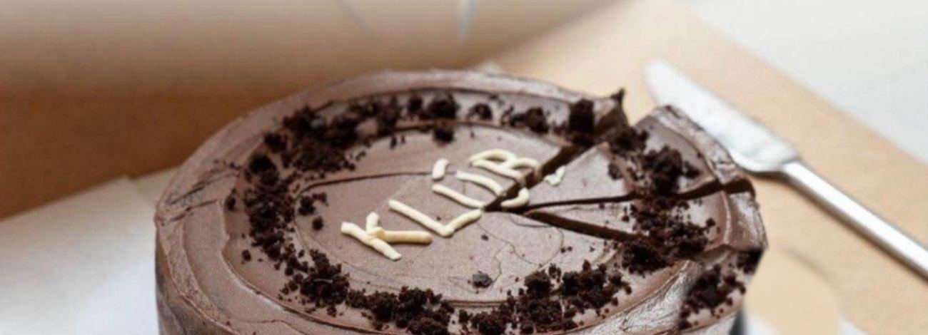 Chocolate birthday cake with KLÚB piped on top