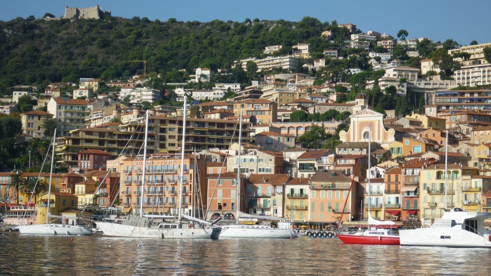 View from the bay towards Villefranche-sur-Mer’s Old Town and hills
