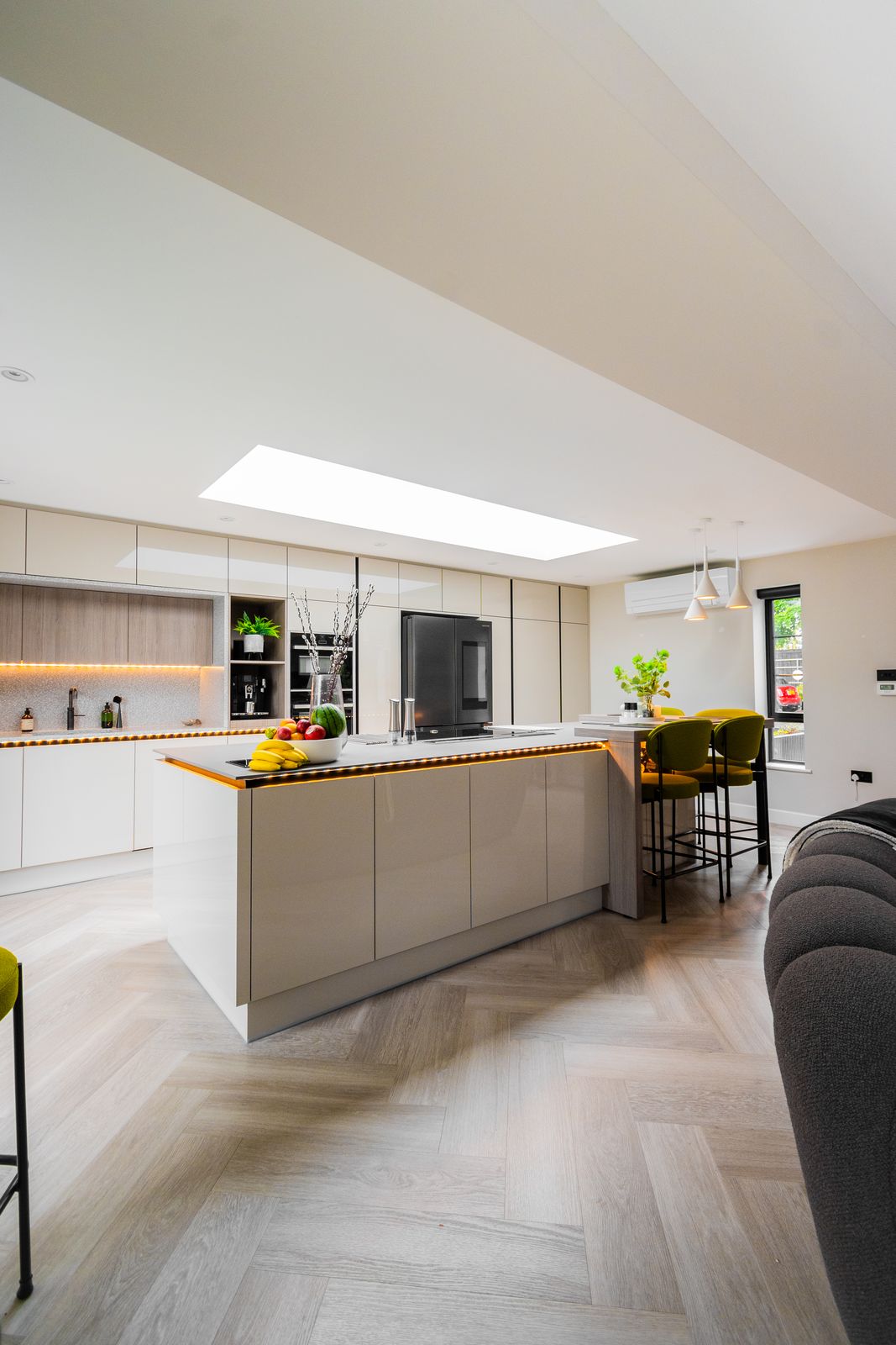 Open-plan handleless light grey kitchen with large island under a roof lantern, Kings Road, Peterborough
