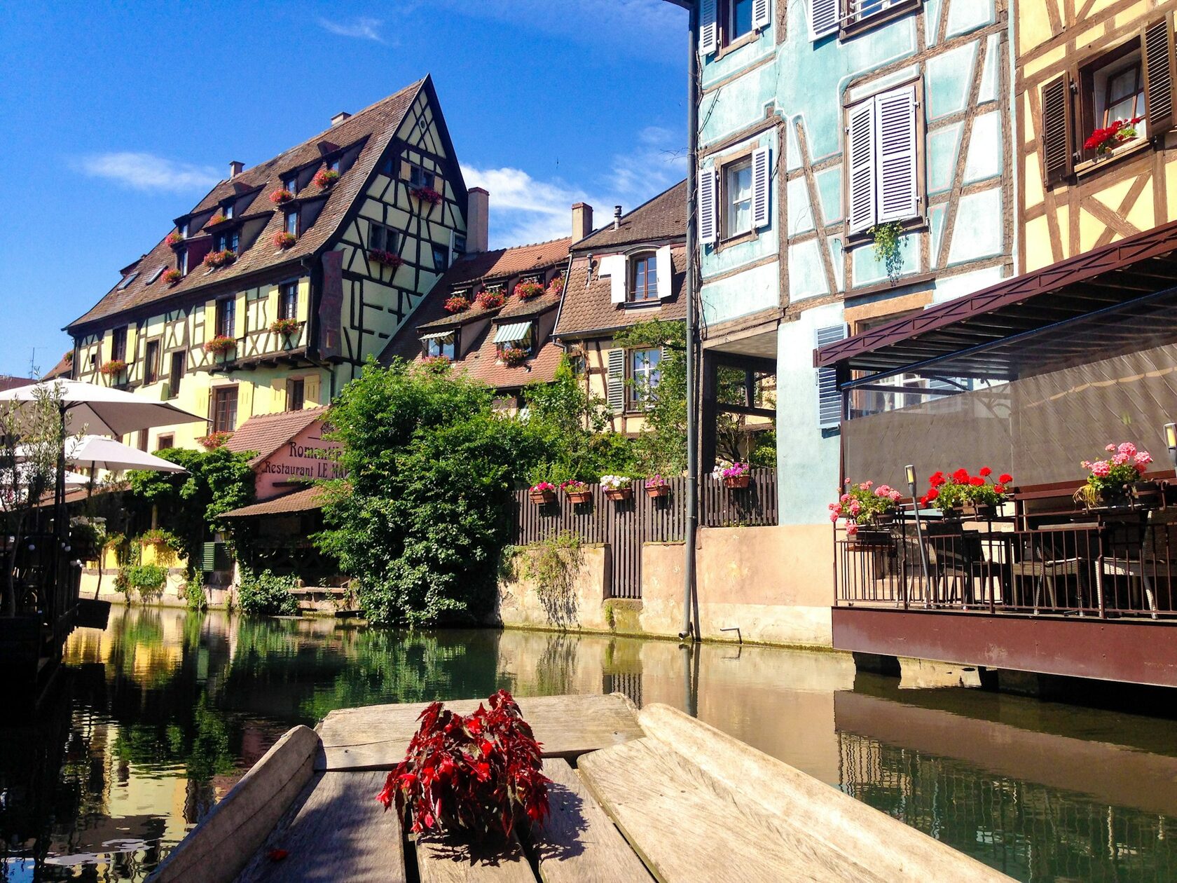 Colmar's Little Venice with pastel half-timbered houses and flower boxes along the canal