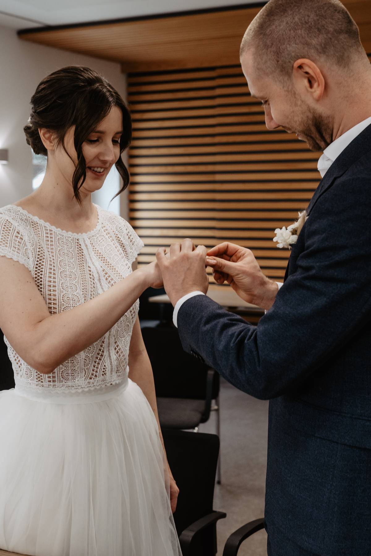 Bride and groom exchanging rings at the registry office