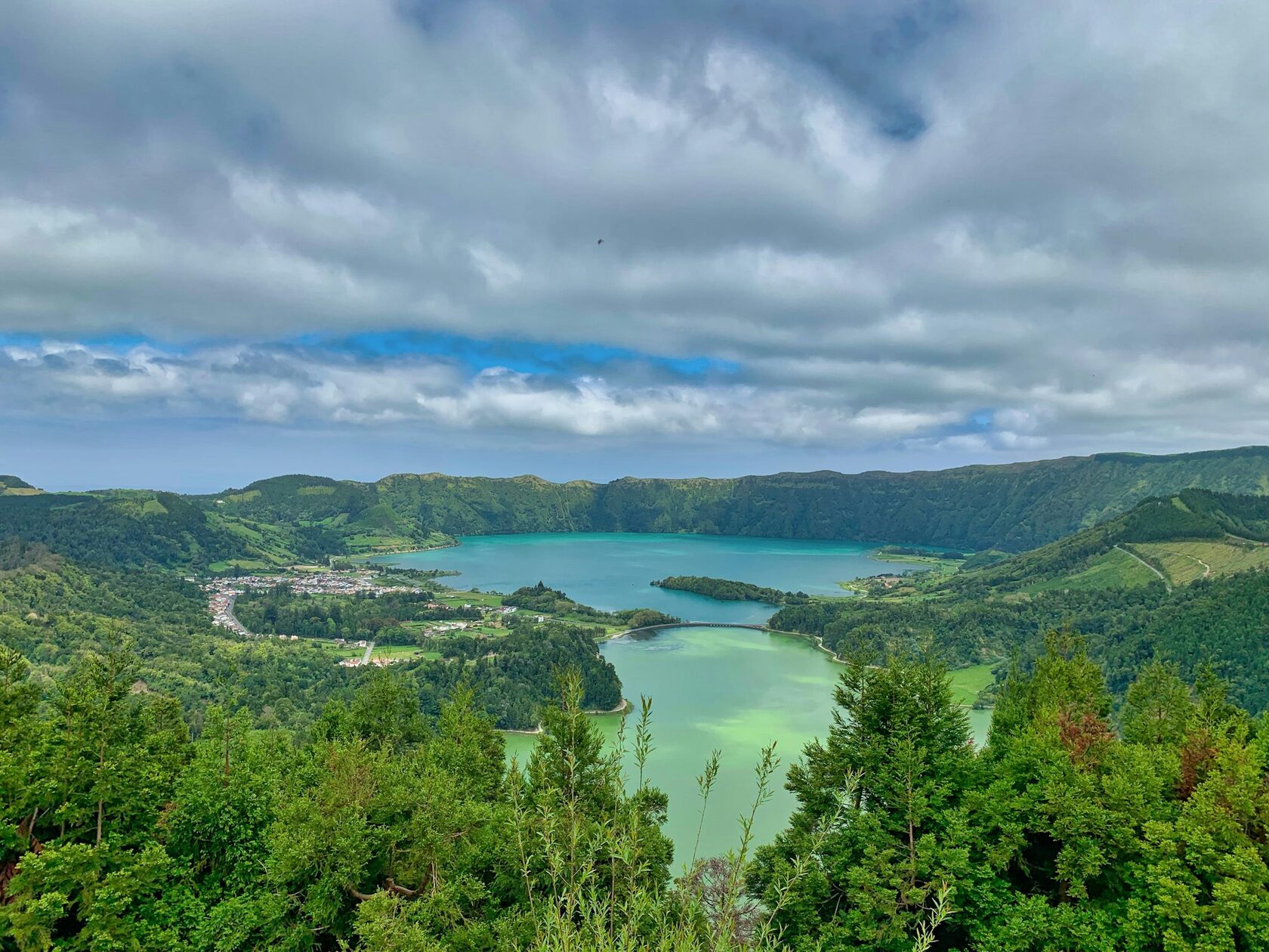 The twin crater lakes of Sete Cidades, one blue and one green, seen from the Vista do Rei viewpoint on a clear day