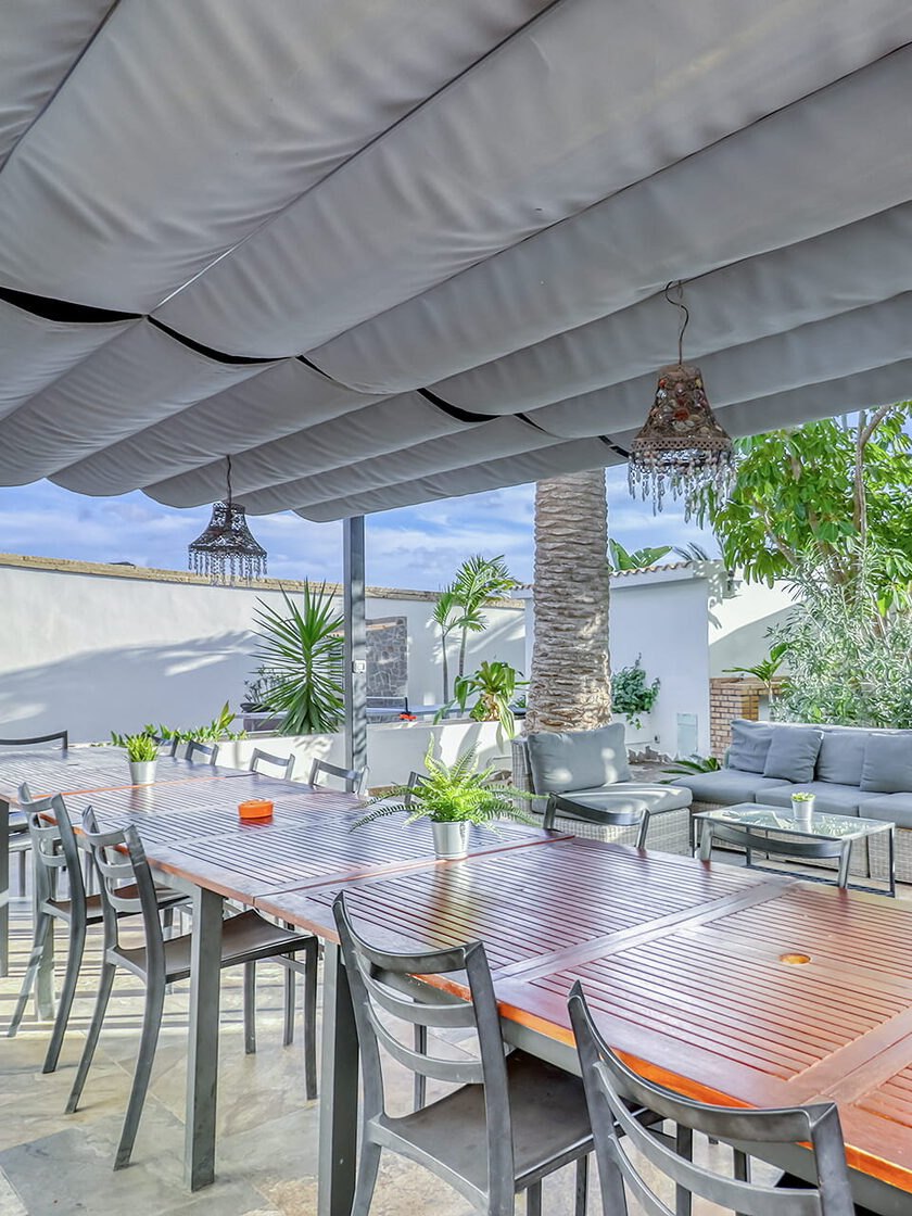 The long dining table under the awning