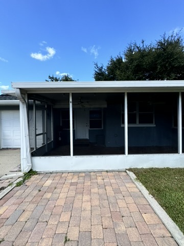 White screen porch on pavers with a new door