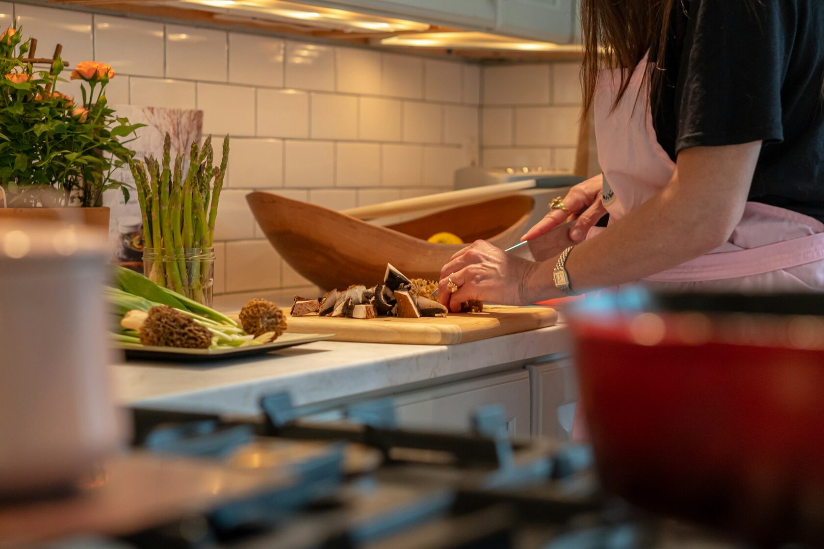 Hands shaping dough in a warm kitchen