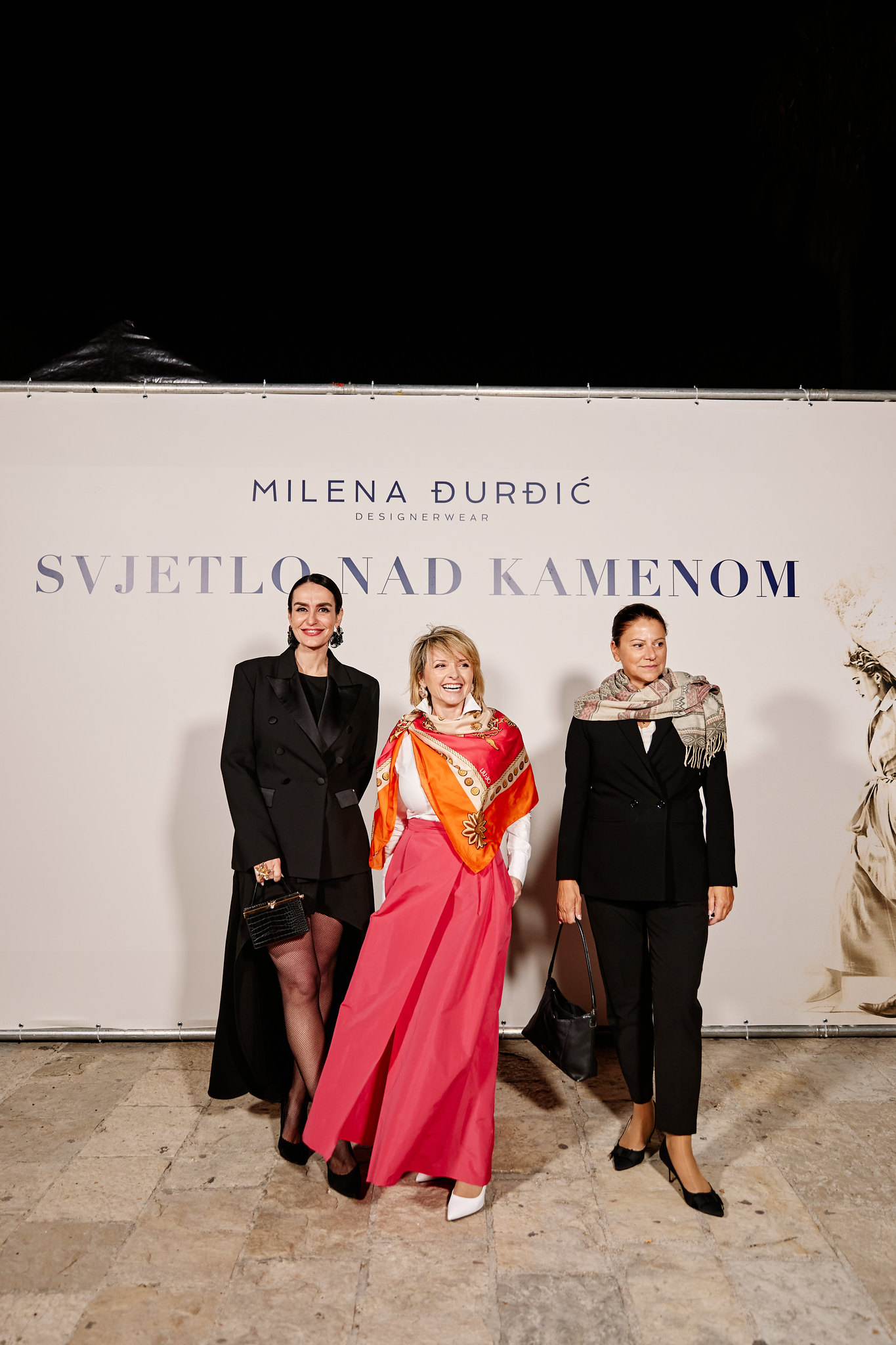 Guests in front of the event backdrop