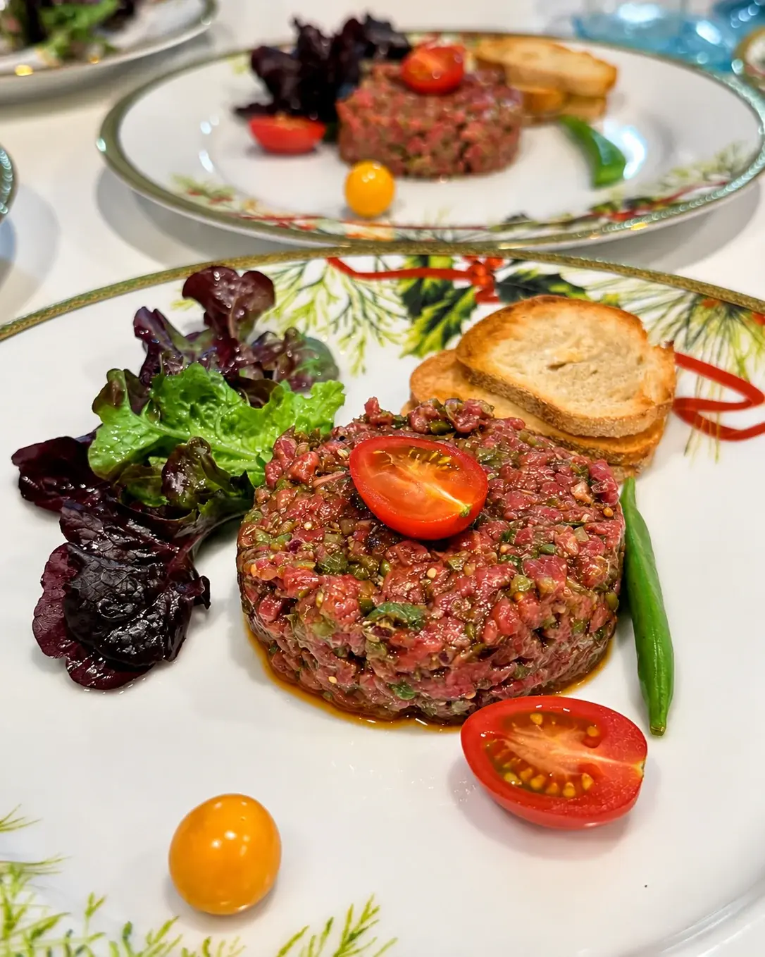 Beef tartare on a Christmas plate — a Christmas dinner at home by Miami private chef Marina Staver