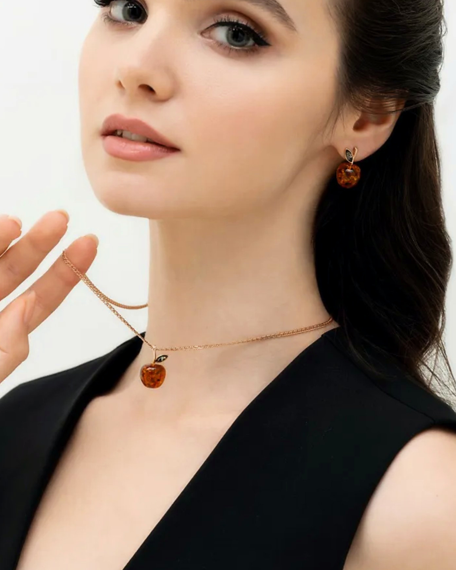 Model wearing the amber apple pendant and a matching stud earring