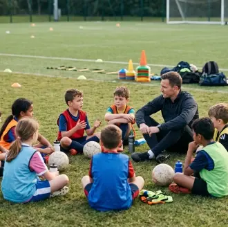 Coach holding two young athletes in a training hall