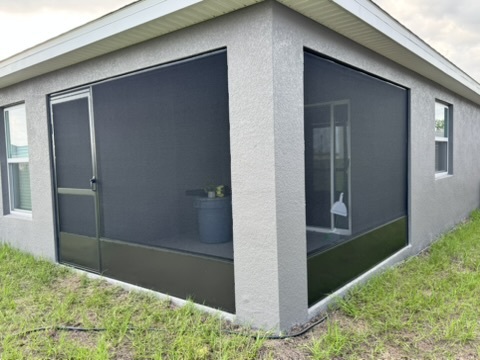 Gray lanai after rescreening with bronze kickplate