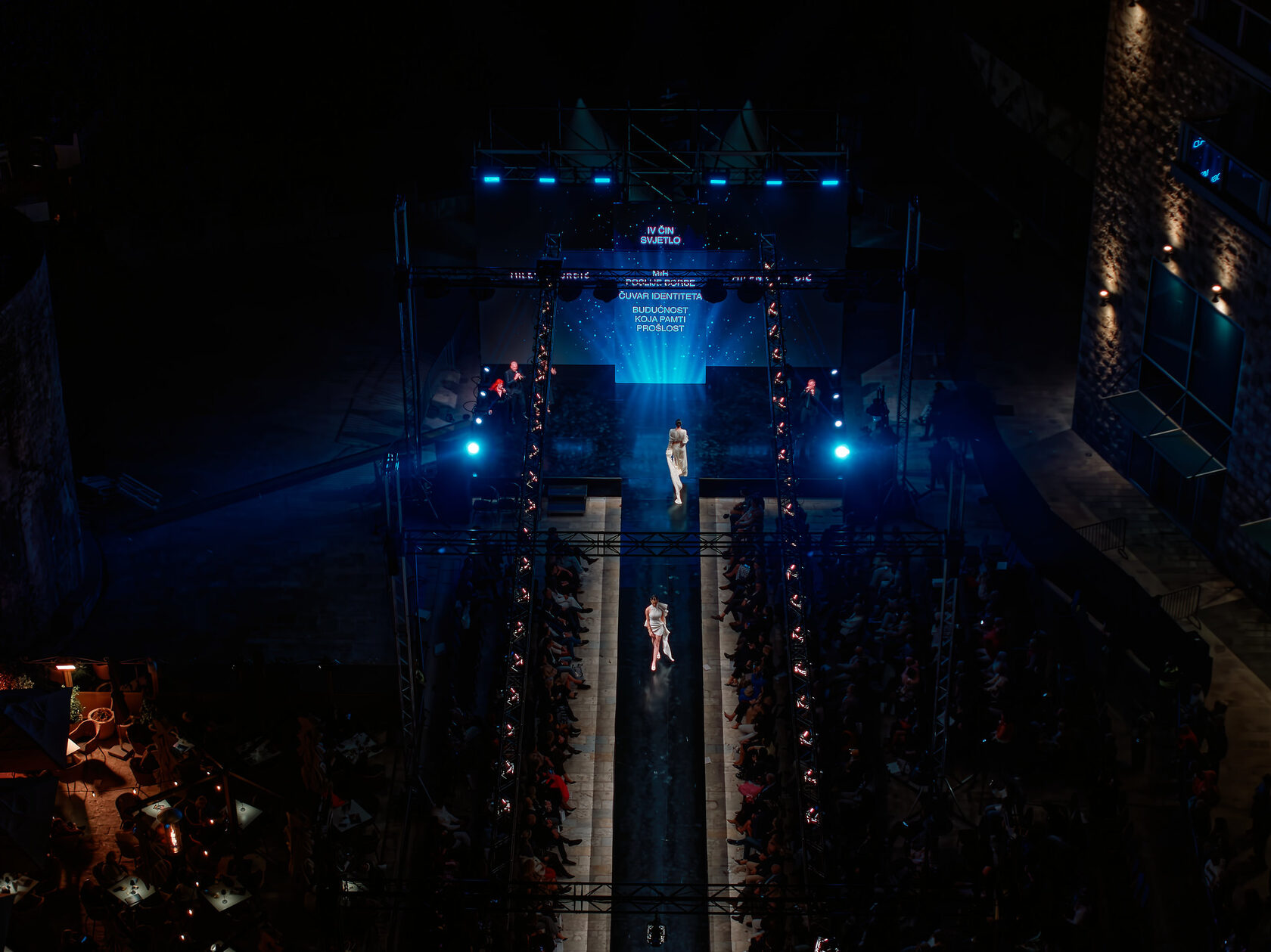 An aerial view of the runway and blue stage lights