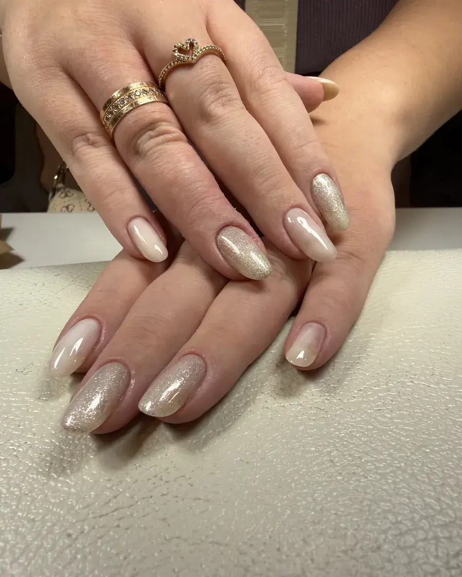 Oval nails in nude gel, with champagne shimmer on alternating nails
