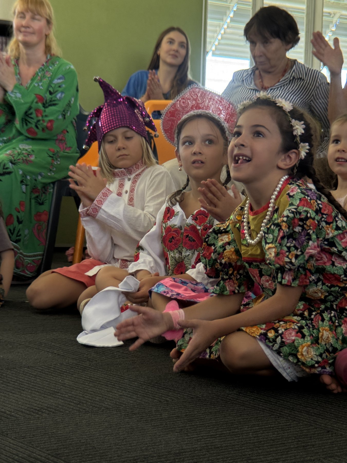 Children and parents watching a school performance