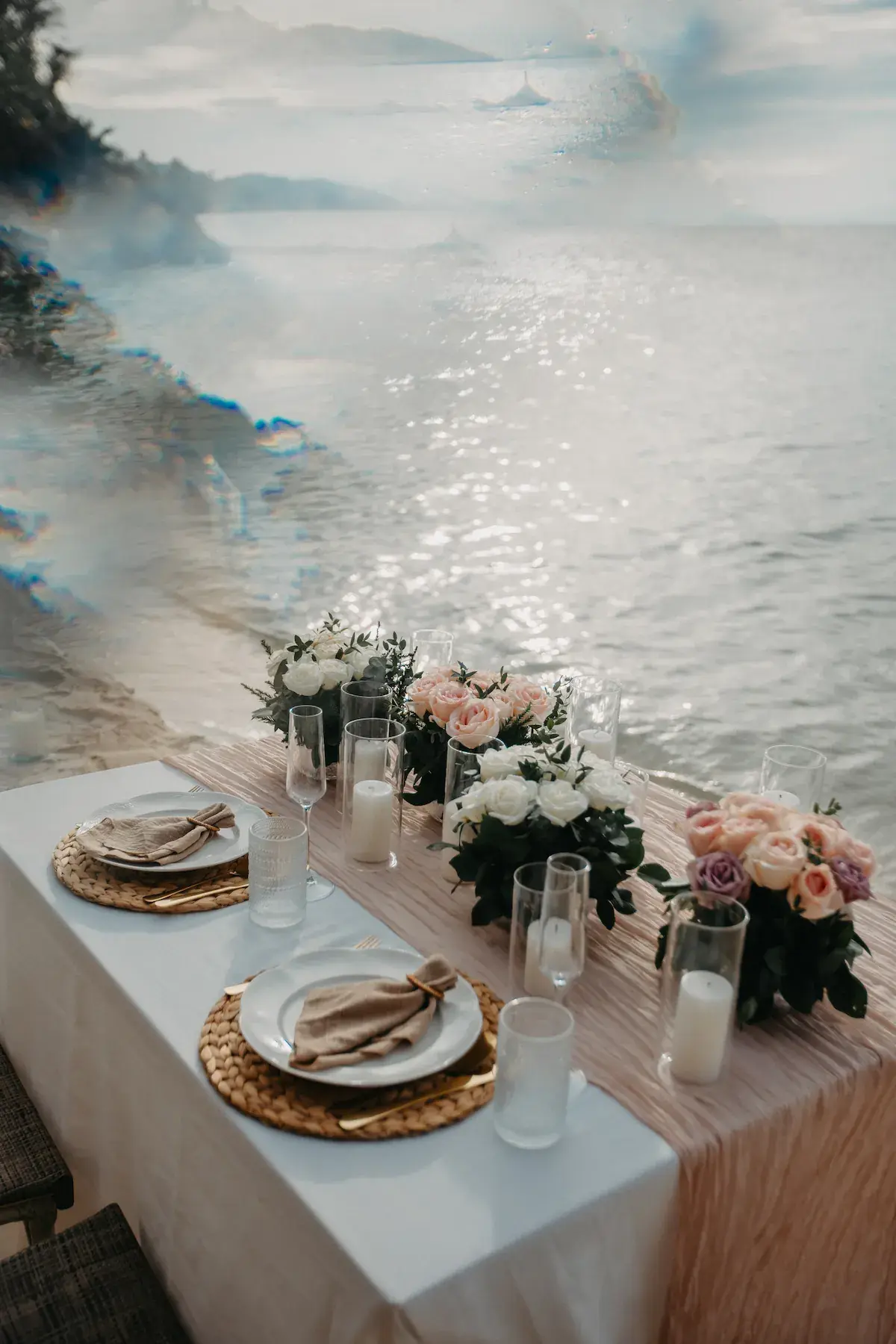 Elegant romantic dining table with flowers overlooking the sea in Koh Samui, Thailand