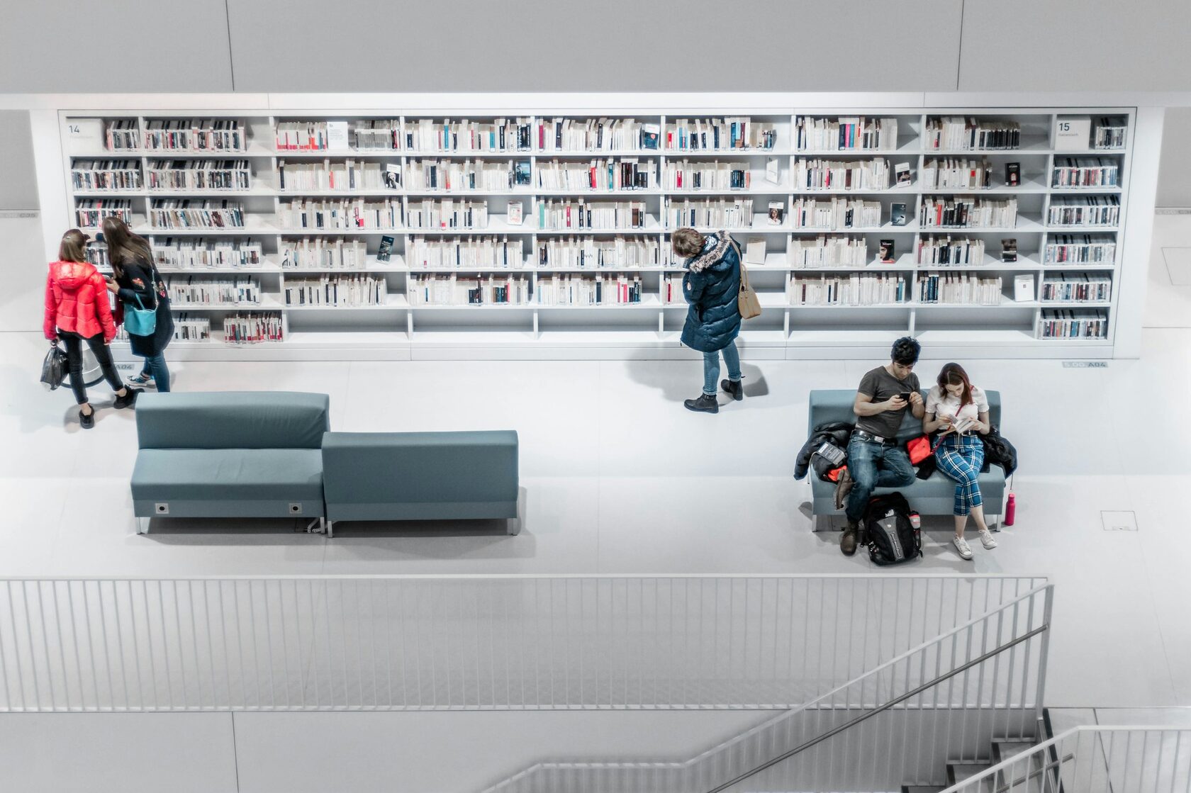 Students working together at a long table in the university library