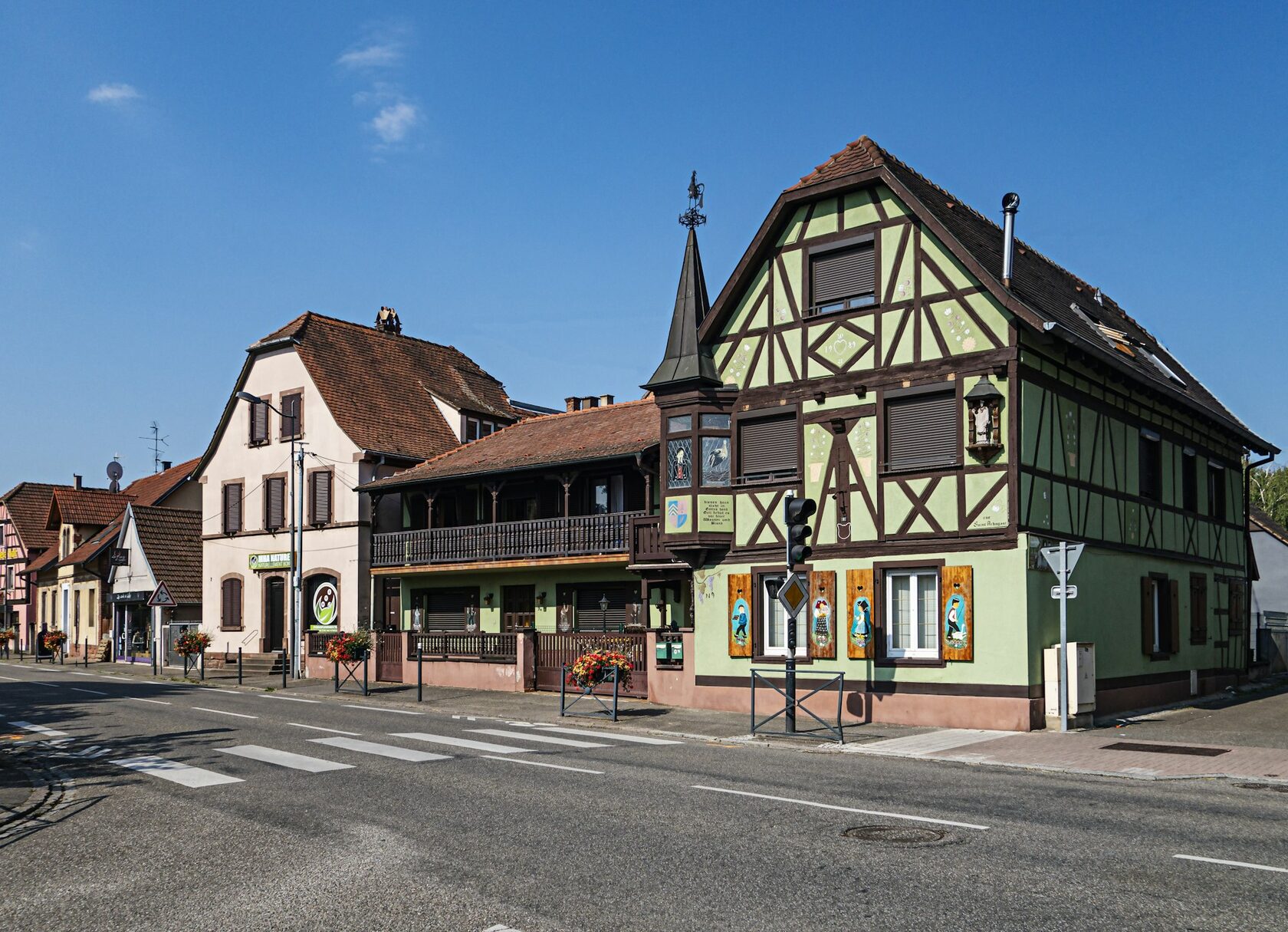 The main street of Riquewihr in Alsace with half-timbered houses and flower boxes in summer