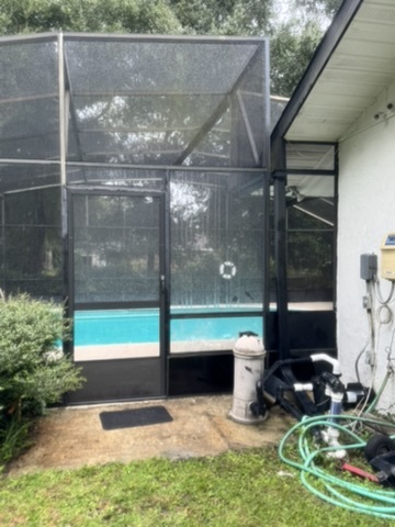 New screen door installed in a pool cage