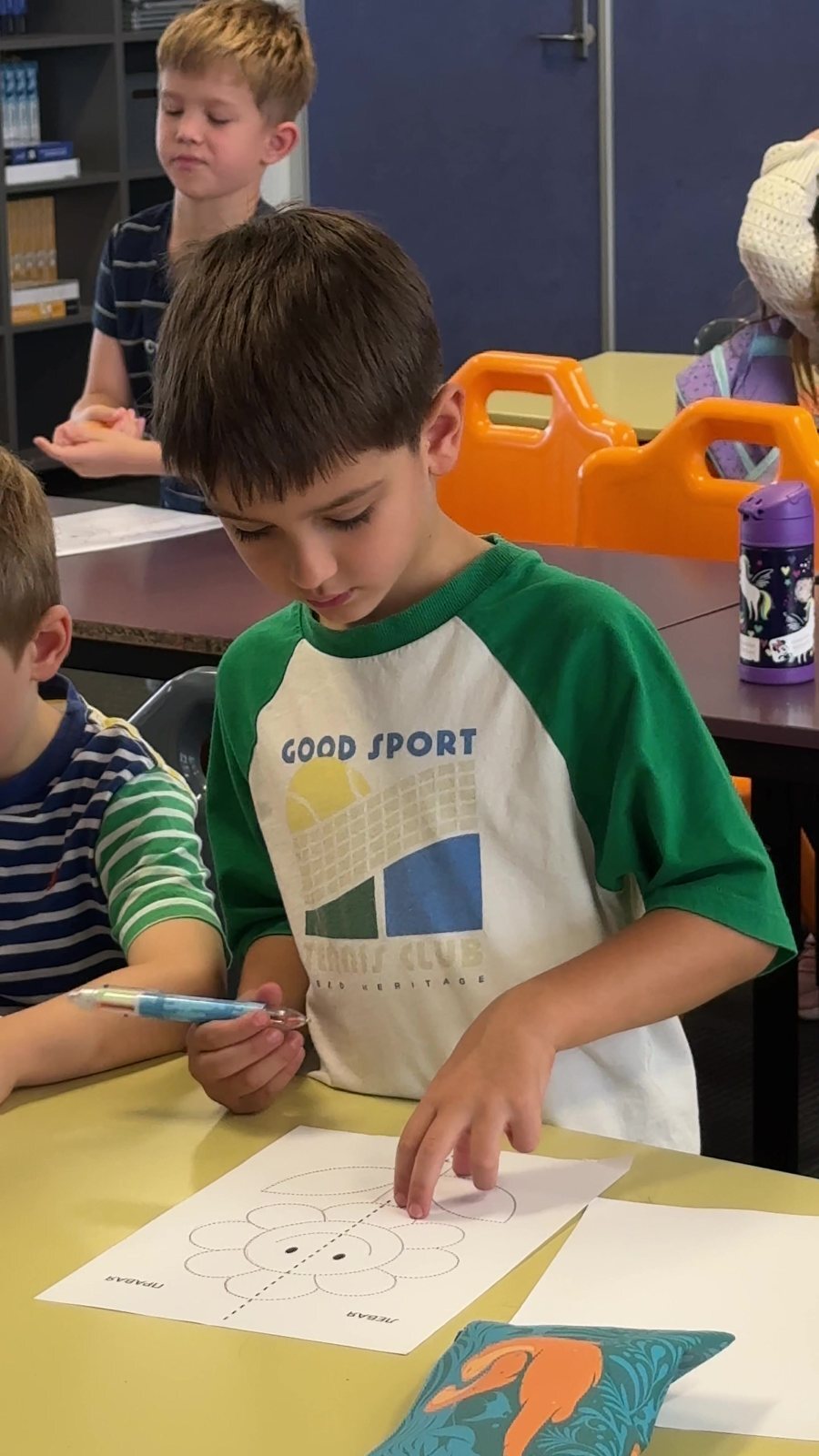 A boy working on a task at his desk