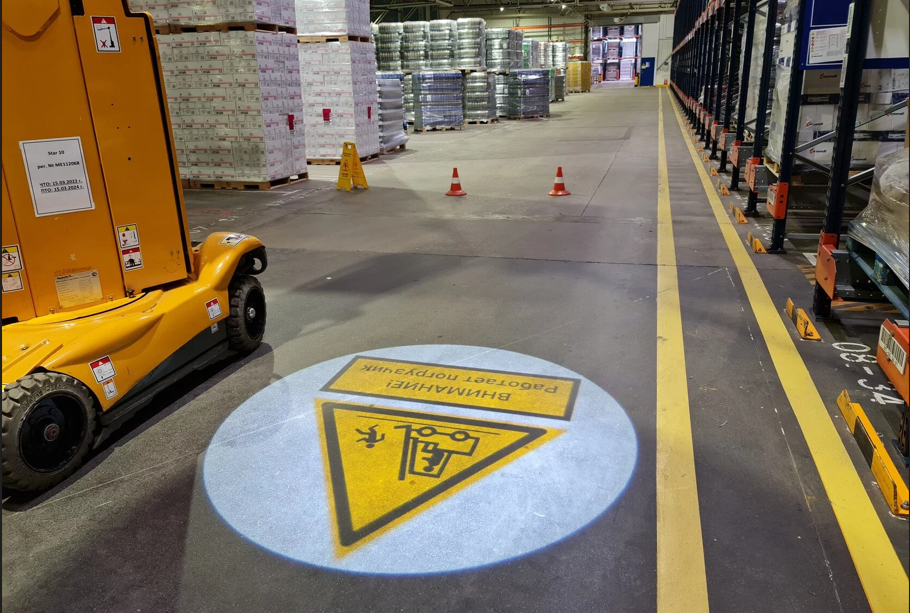 Projected floor marking compared with painted warehouse safety lines