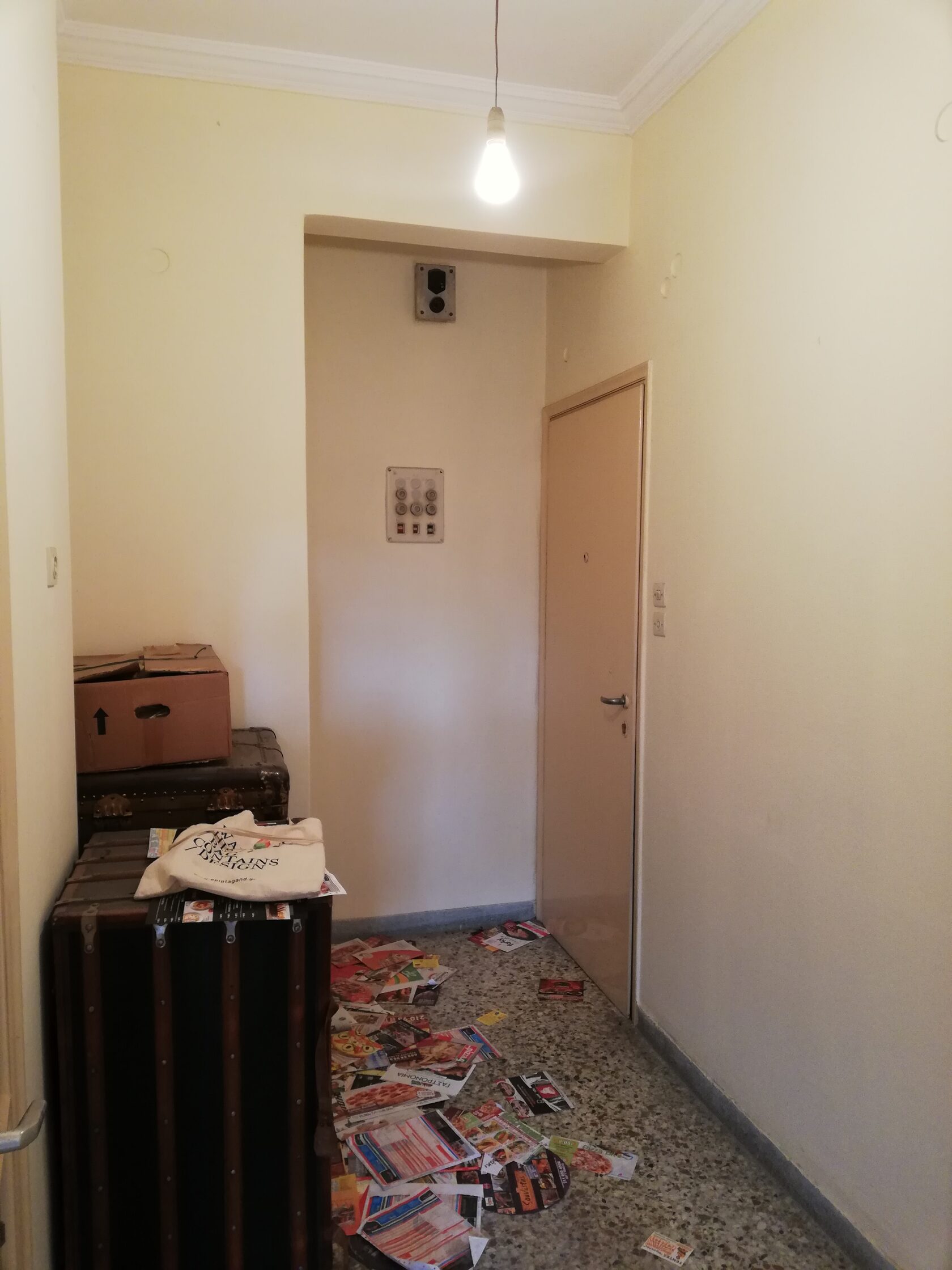 Kitchen before renovation, dated cabinets, dim lighting