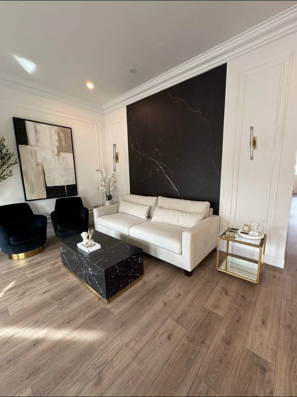 Marble-look accent panel wall with picture-frame wall molding