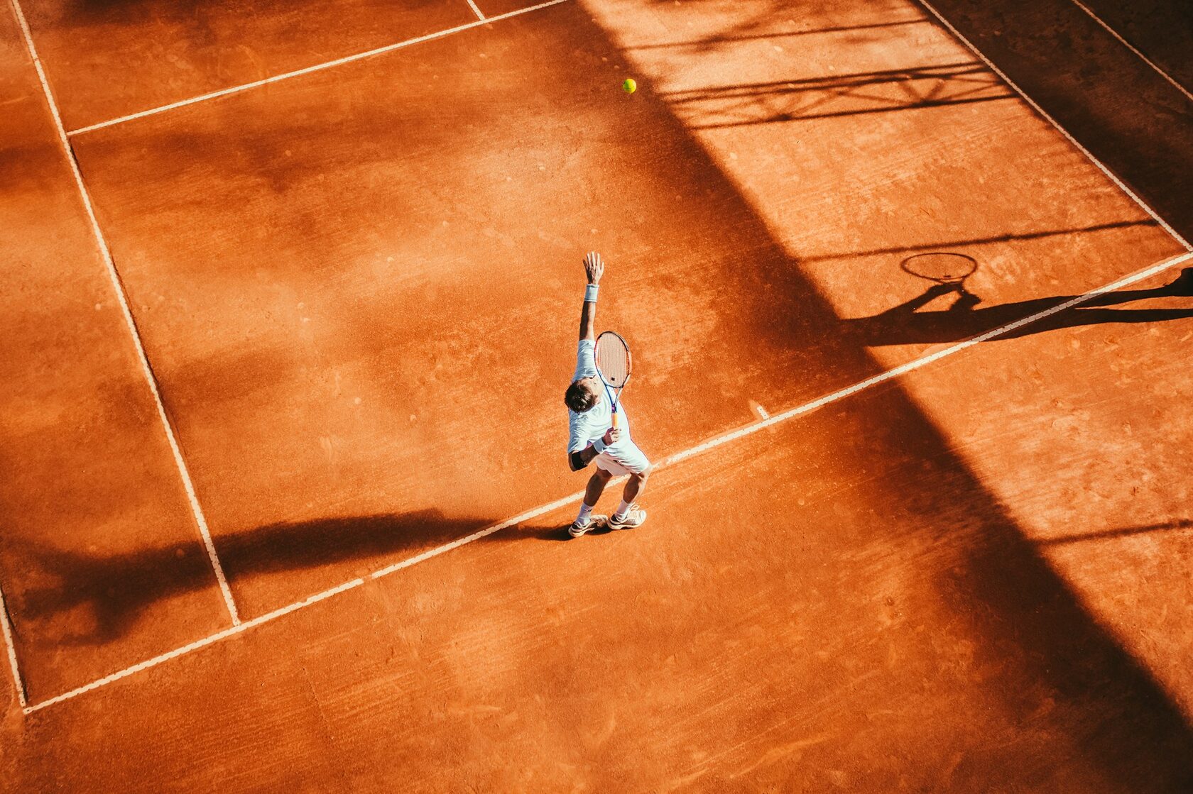 A member of the STS Tennis Academy coaching team on court