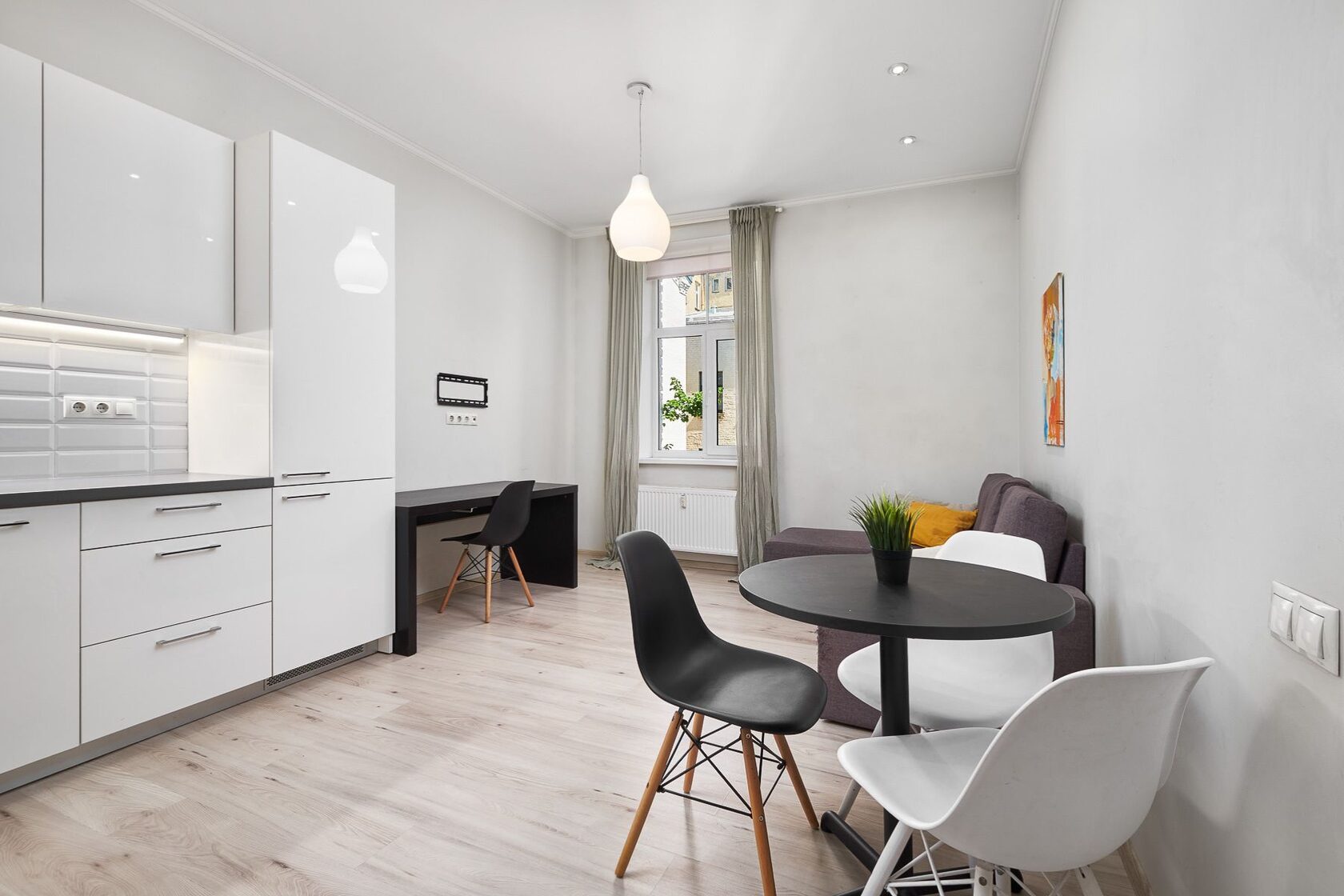 Living room with open-plan kitchen at Lāčplēša iela 53 — bright, functional layout