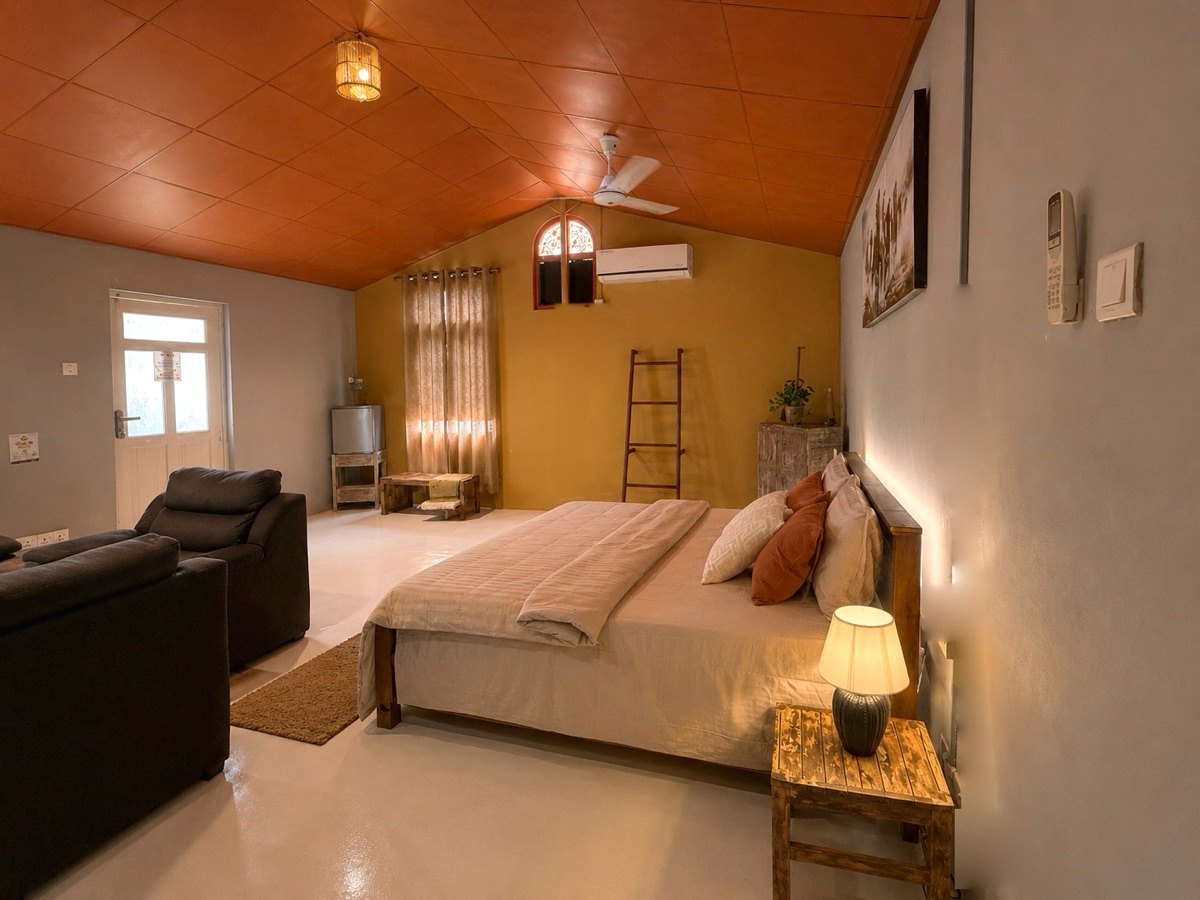 A second view of The Tack Room showing the bed, sitting area and air-conditioning at Vonfidel Ranch